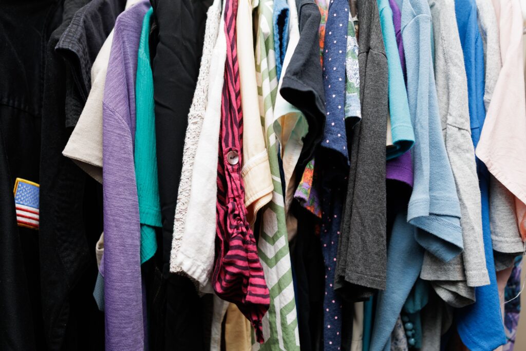 Close up of different colored shirts hanging on rack